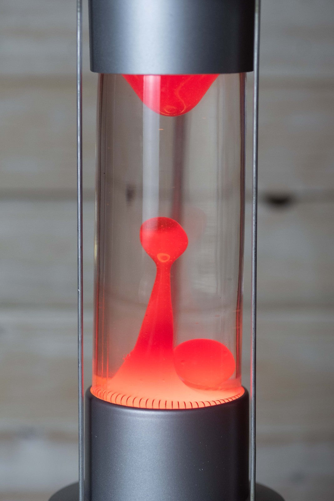 Close-up of red double wax flowing inside the Raduga lava lamp bottle